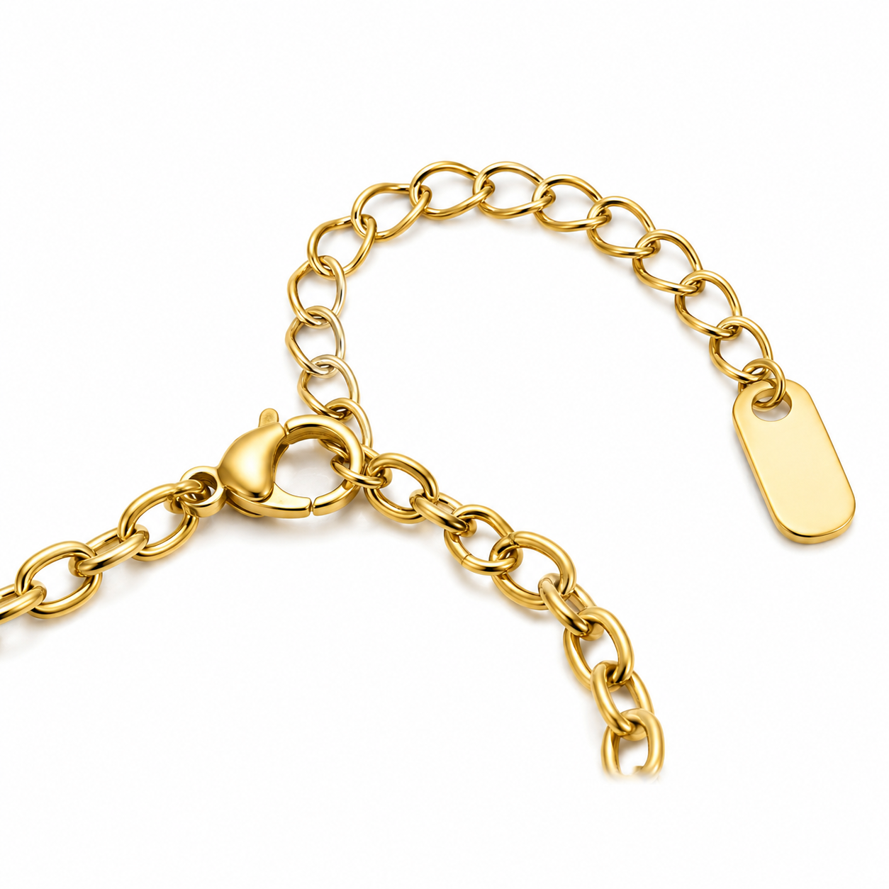Gold plated rainbow and dove charm bracelet with pearl accents worn on a woman's wrist against a beige background.